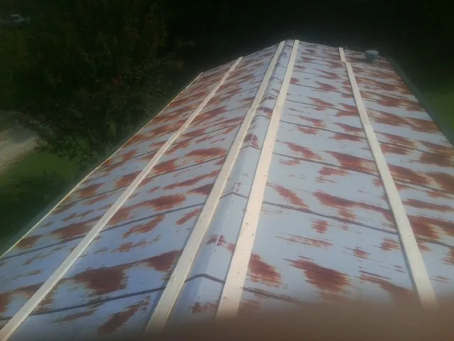 Rusted metal roof panels with new wood purlins before replacement — Storm Damage Roof Repair in Gerber by Roofing Brothers